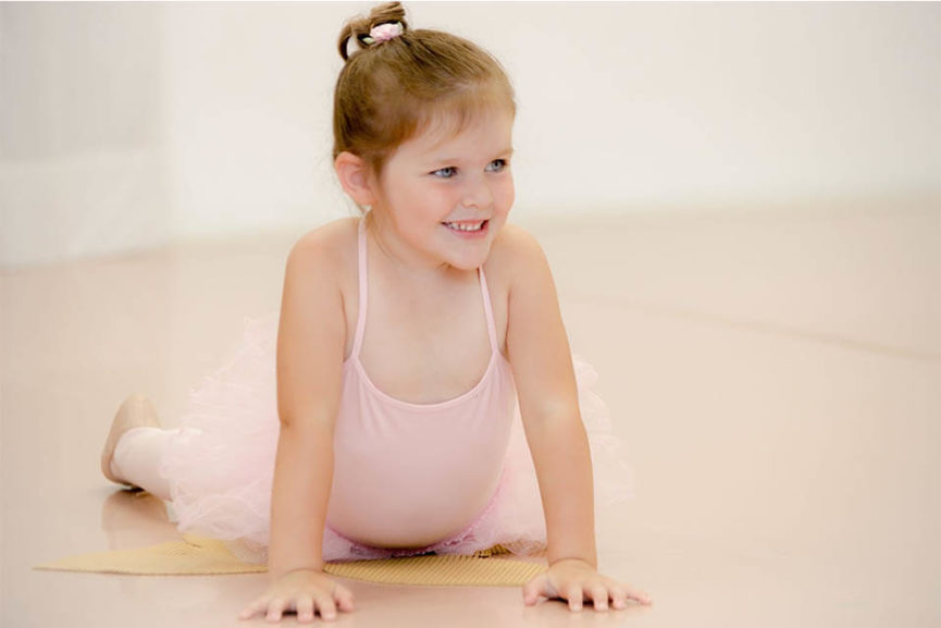 little girl in pink tutu dresses as a ballerina