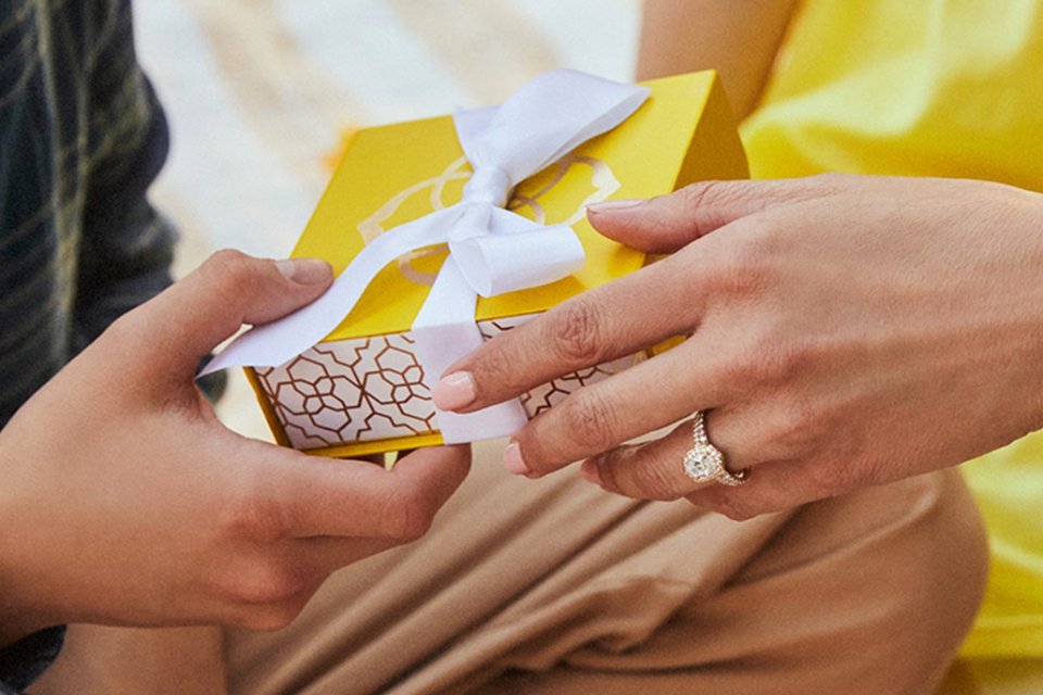 kendra scott yellow gift box between hands