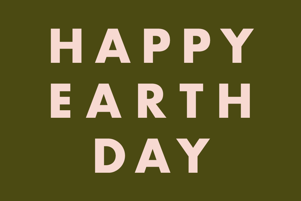 happy earth day written in pink text on green background