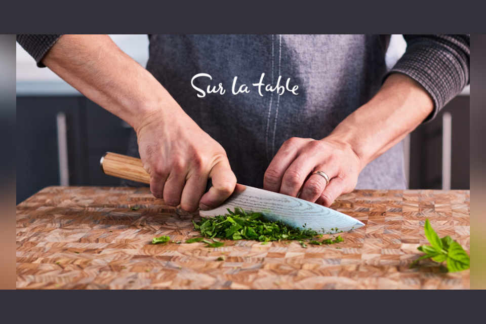 person using sharp knife to cut herbs